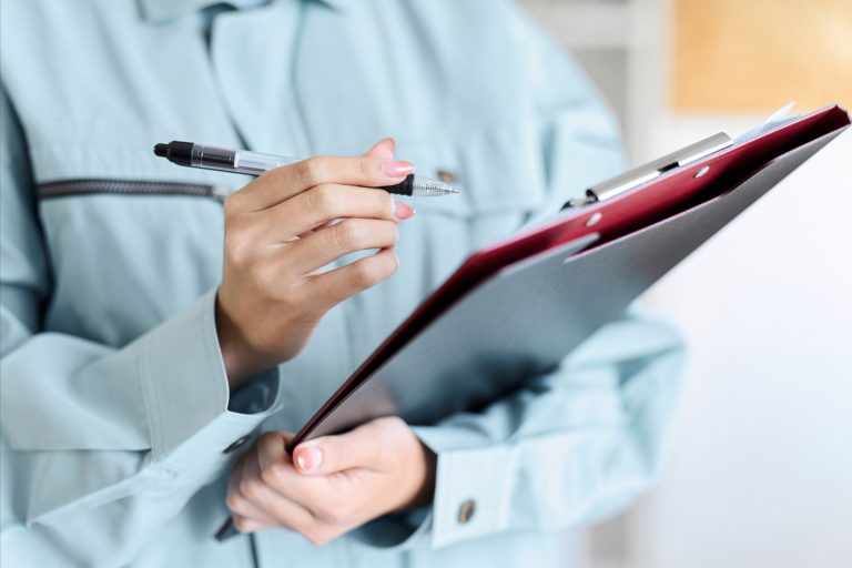 A professional woman comes to your home wearing work clothes to conduct an assessment.