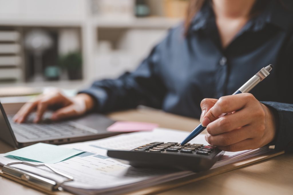 Accountant used a calculator financial analysis managing payroll tax accounting budget accounts.